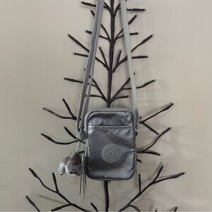 Brand new”Kipling”mini crossbody bag.Size-w5”x7”inc.Color-smooth silver metallic